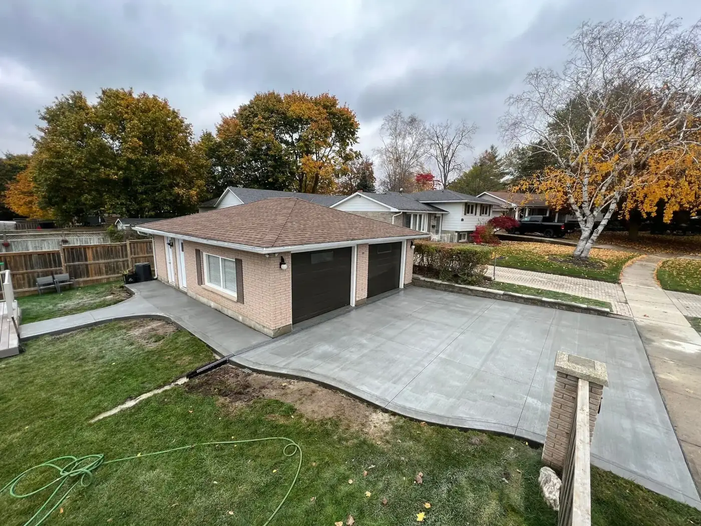 New broom finish concrete driveway leading to a detached garage in Halifax, NS