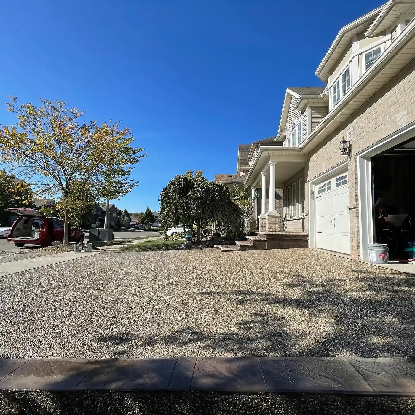 Exposed aggregate concrete driveway beside a two-storey home in Halifax, NS