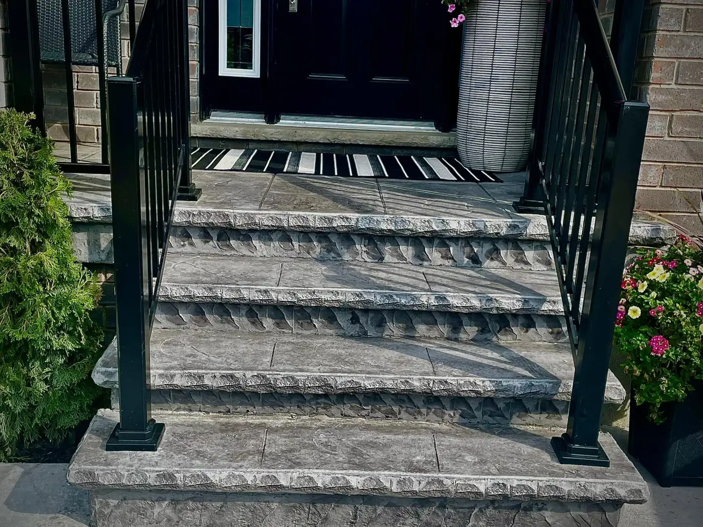 Stamped concrete front steps with black metal railings in Halifax, NS